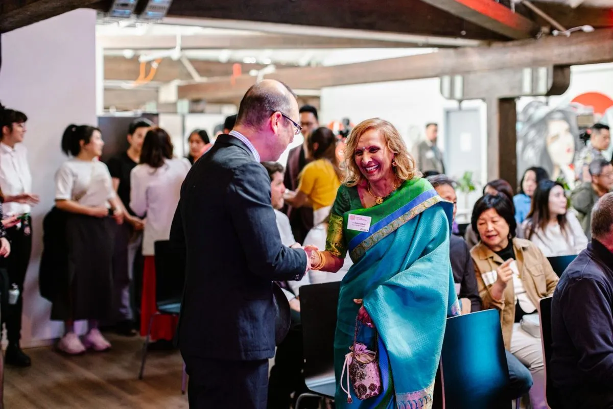 Guests greeting each other at an HHQ community event