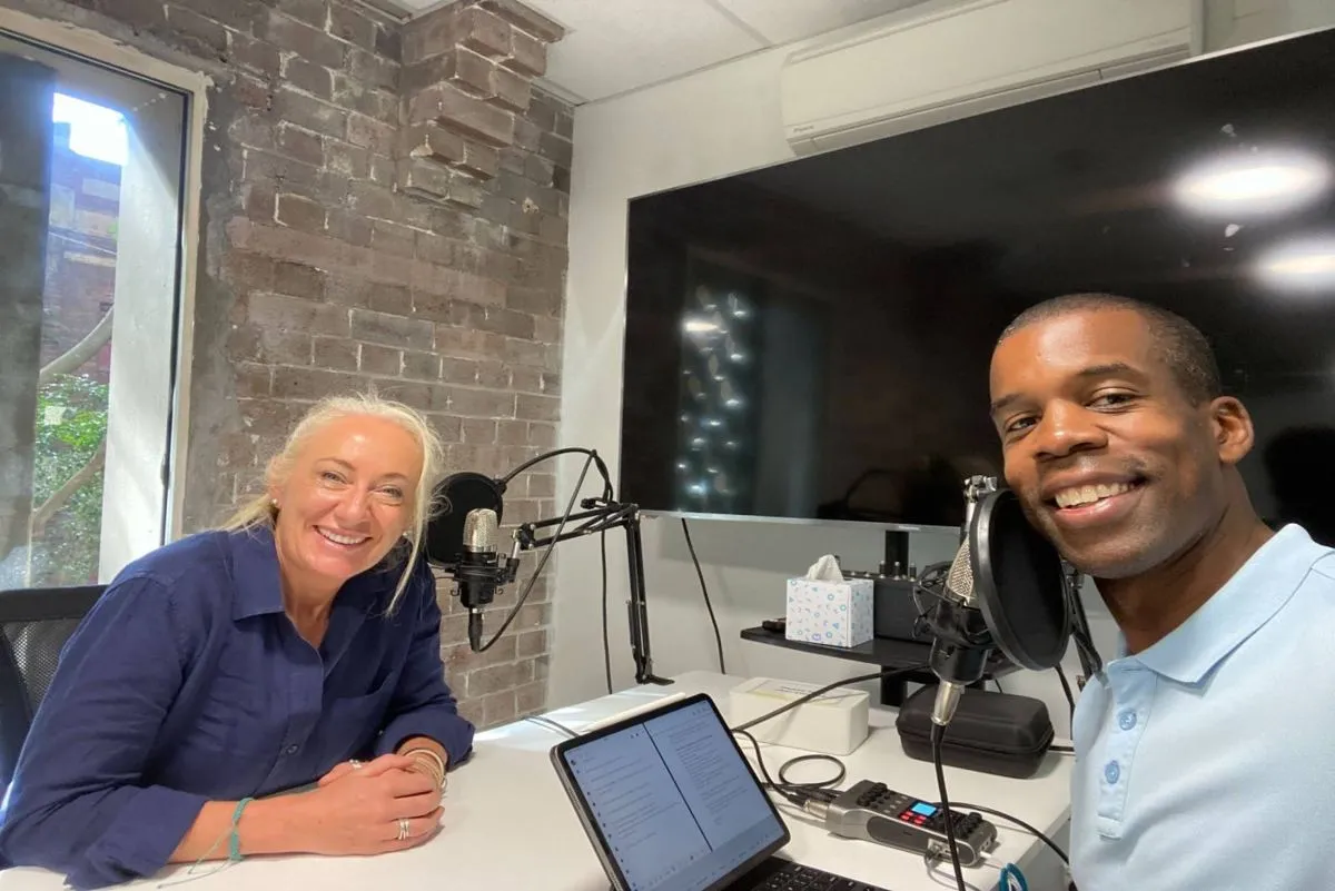 Two people recording in the HHQ podcast studio